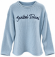A light blue ribbed knit long-sleeve sweater with 'Sanibel Island' written across the chest in dark navy script, shown on a plain white background.